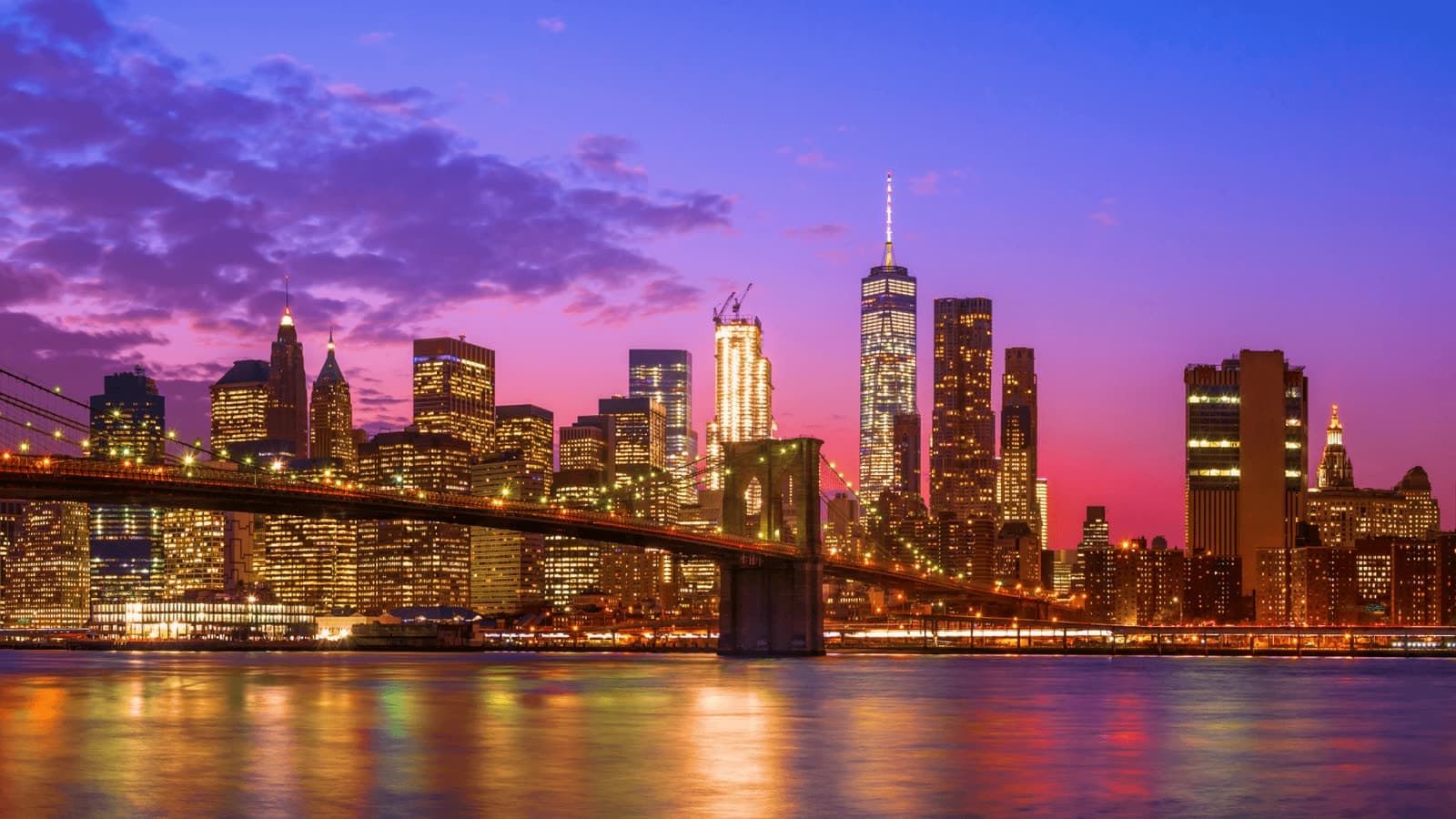 The Brooklyn Bridge and the Manhattan skyline at dusk, where school field trips from New York City begin
