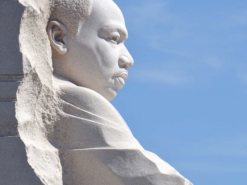 The Martin Luther King, Jr. Memorial statue in Washington, DC against a blue sky