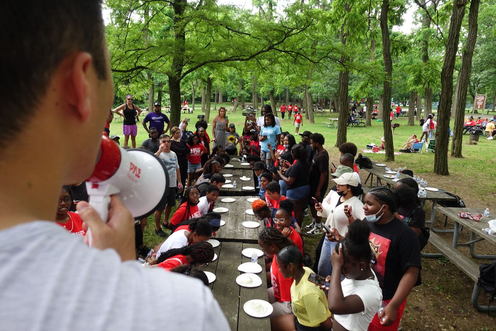 A Richmond Tours staff member with a megaphone starting the pie-eating contest