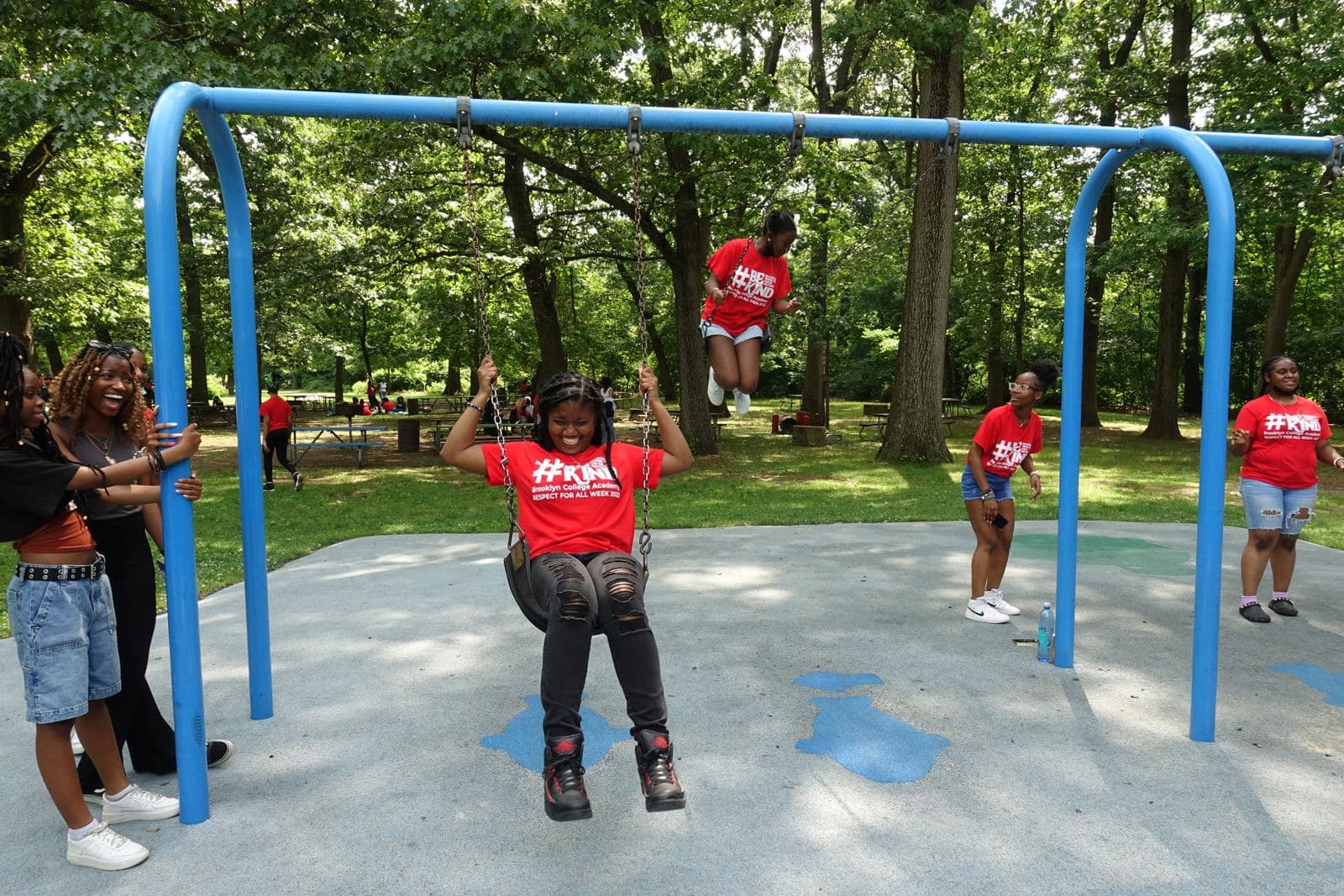 Students laughing on the swings