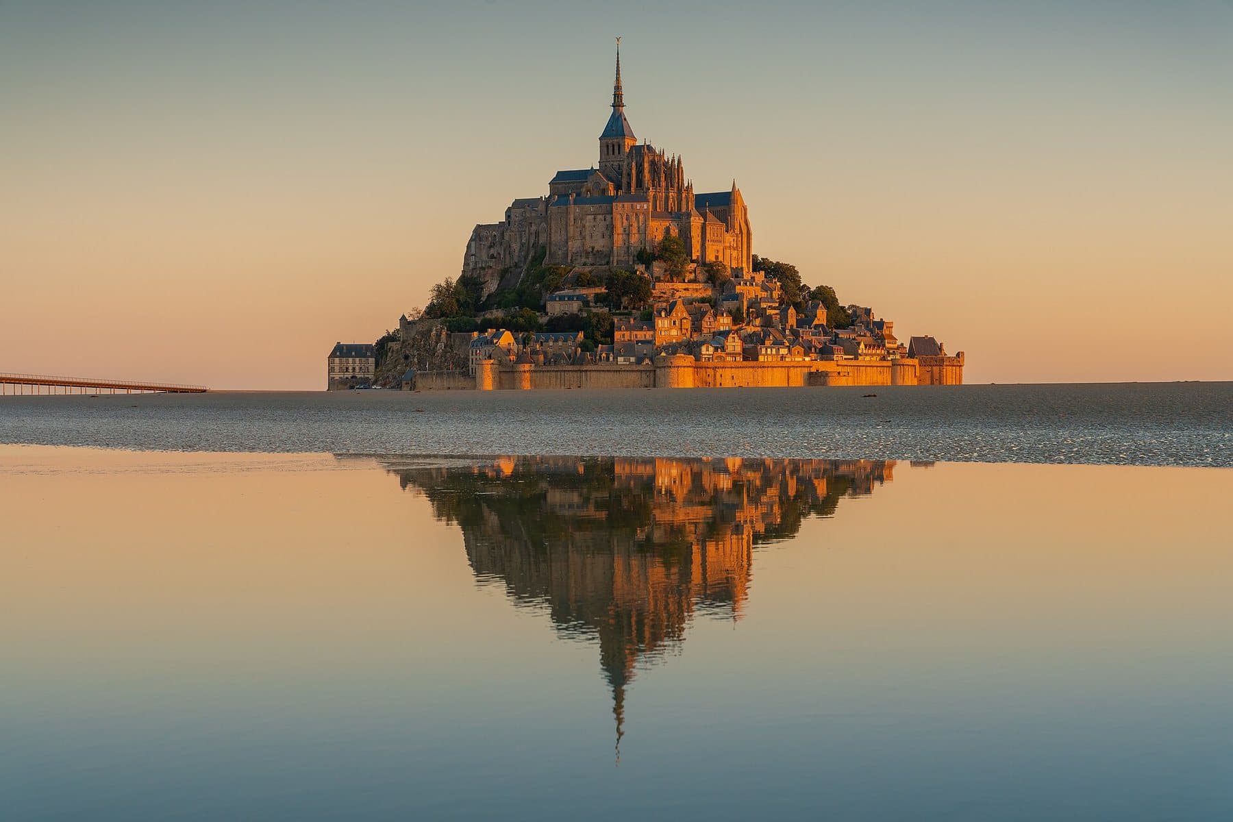Mont-Saint-Michel at sunrise, reflected in the bay