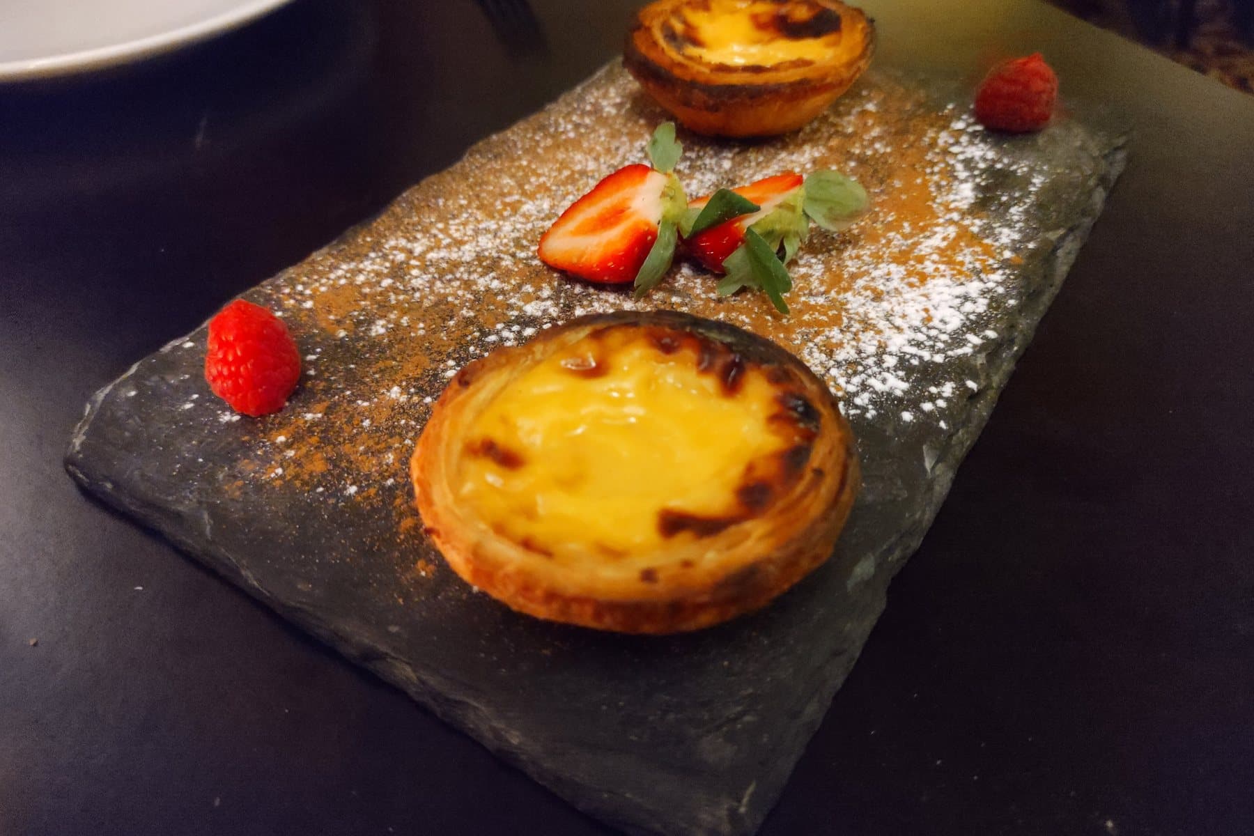 Pastéis de nata on a slate in Lisbon