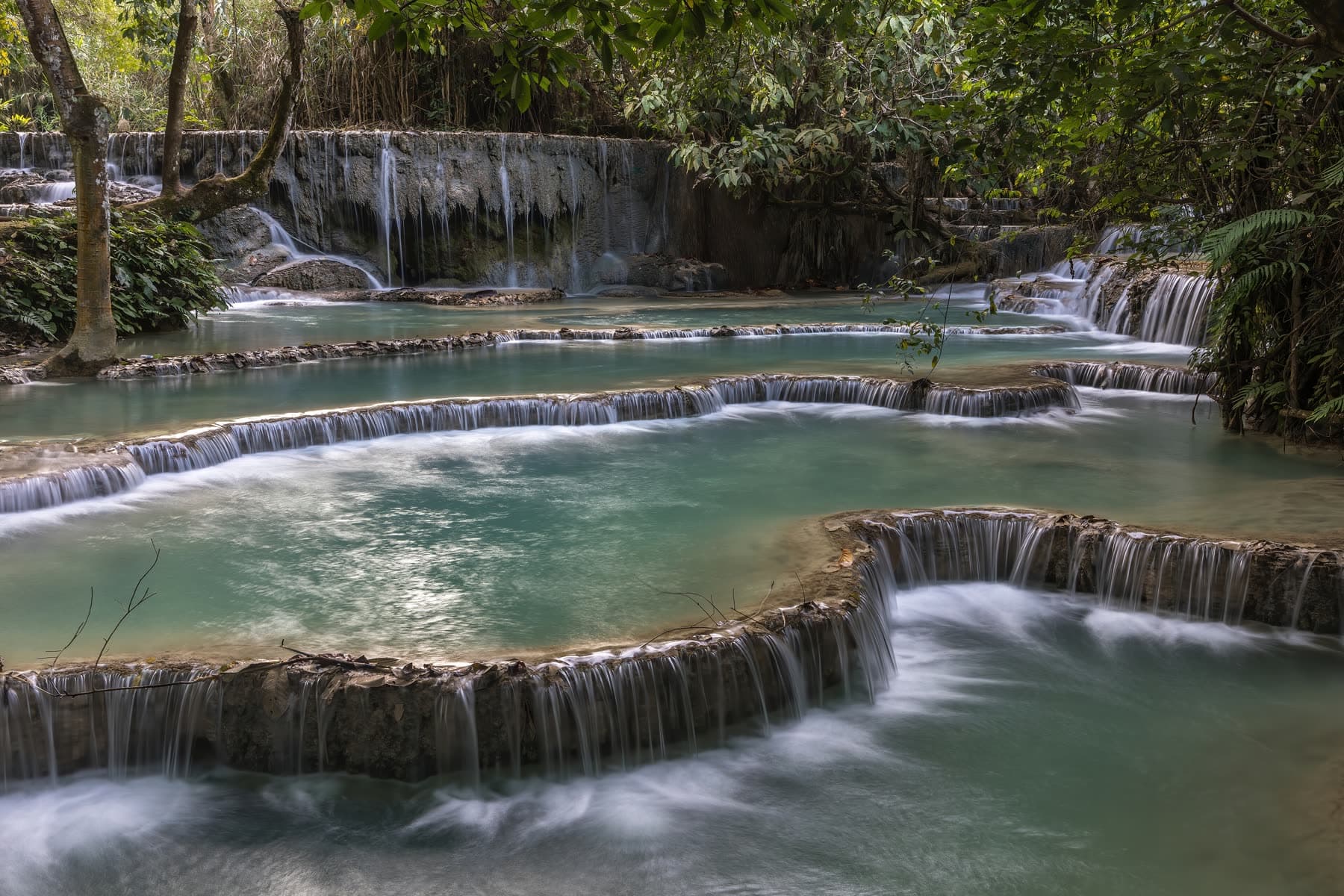 Tiered turquoise pools at Kuang Si Falls in Laos