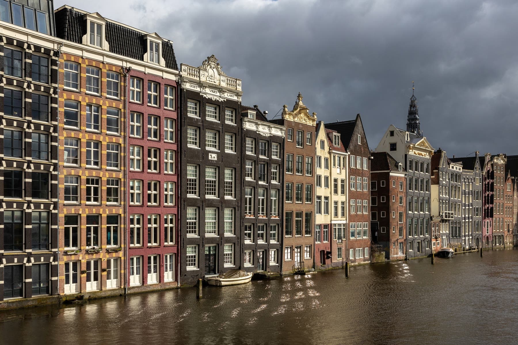 Canal houses along the Damrak in Amsterdam at golden hour