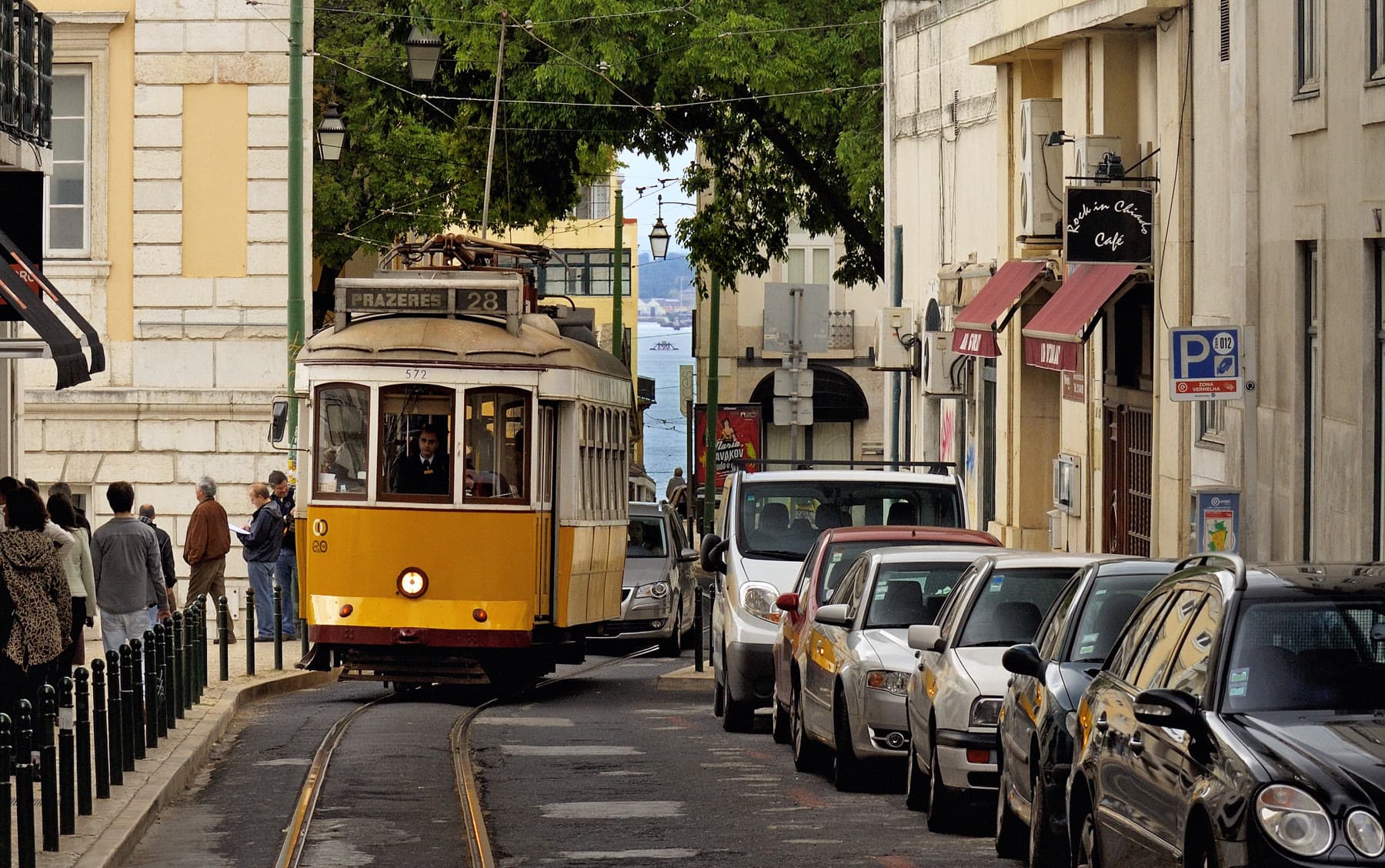 A yellow tram on a steep street in Lisbon
