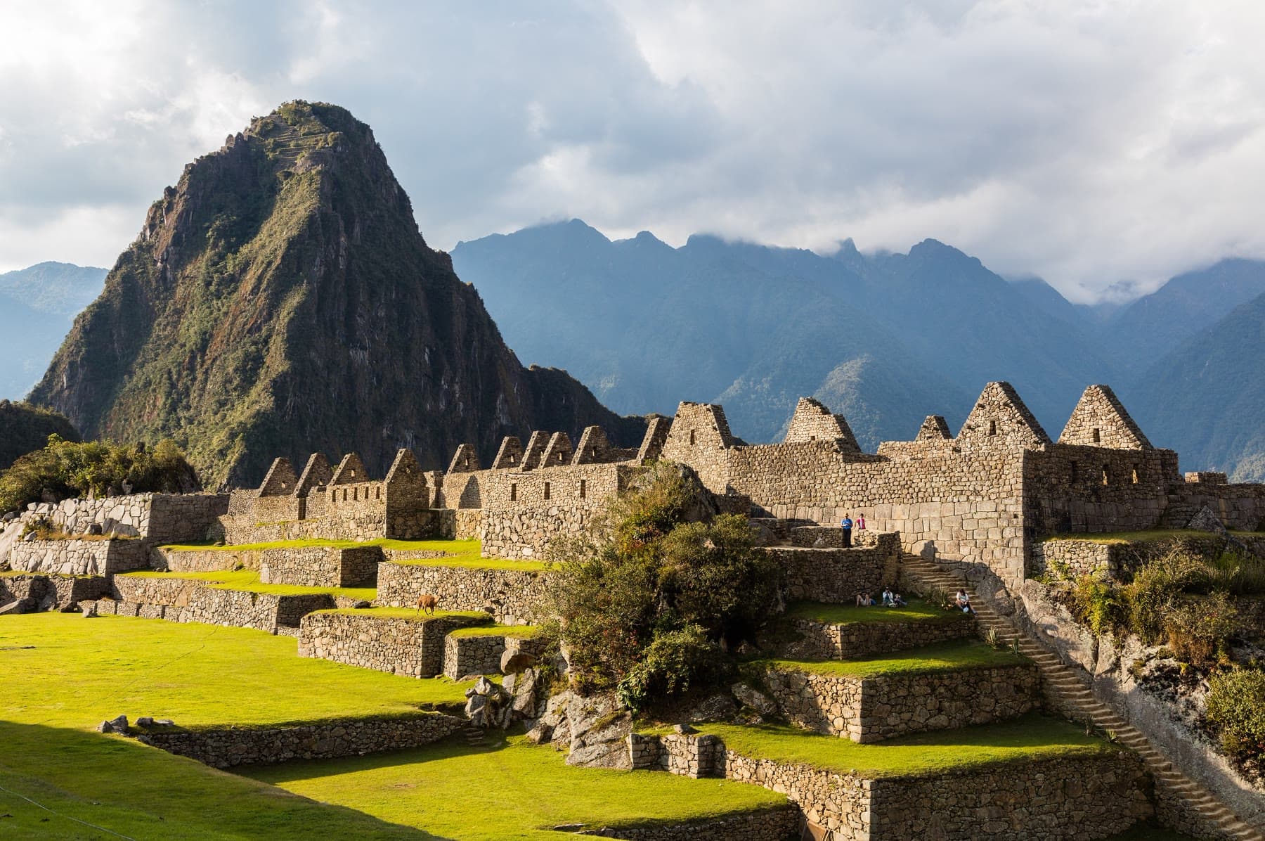 Stone walls of Machu Picchu with Huayna Picchu rising behind them