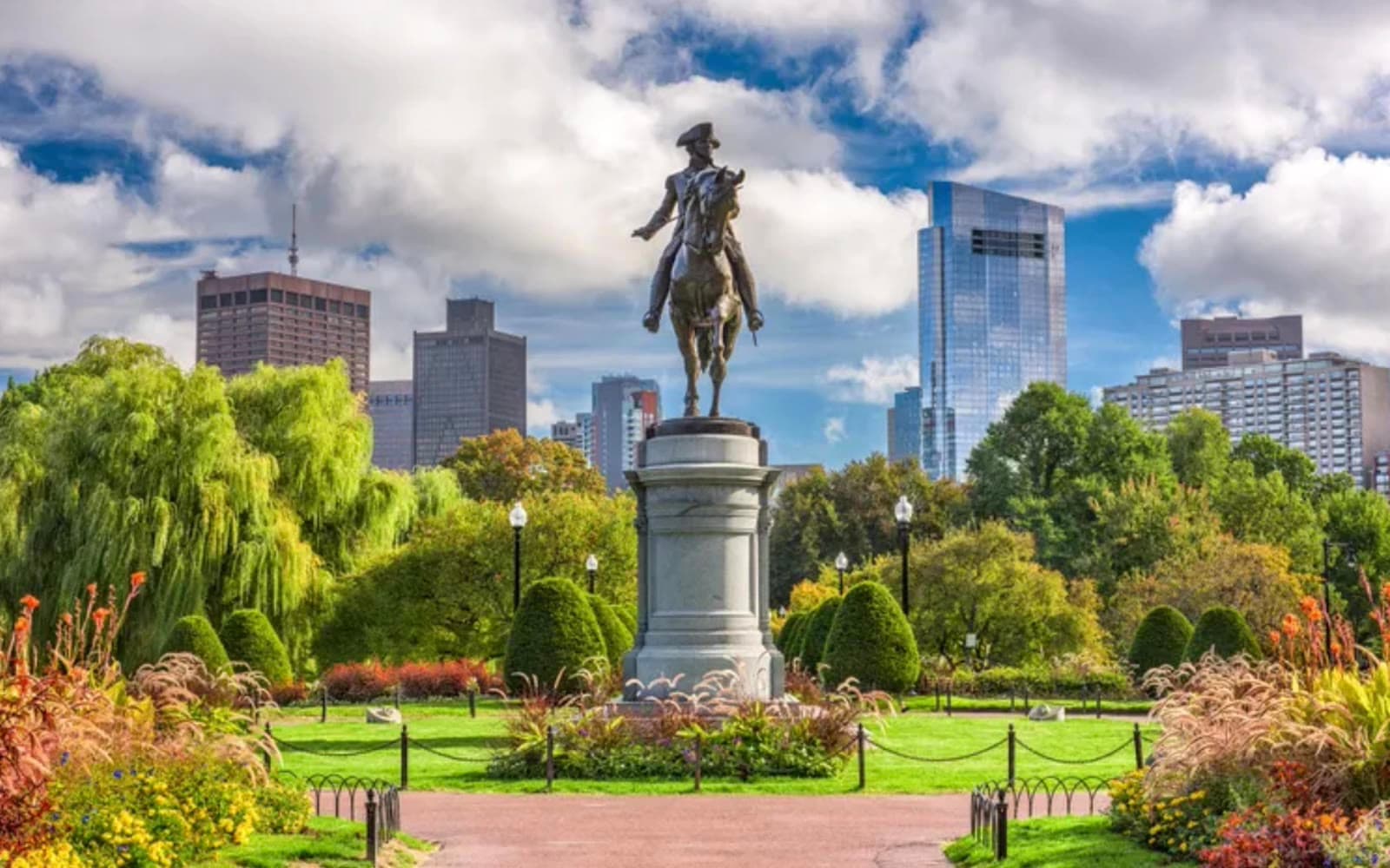 The George Washington statue in the Boston Public Garden, with the skyline behind it