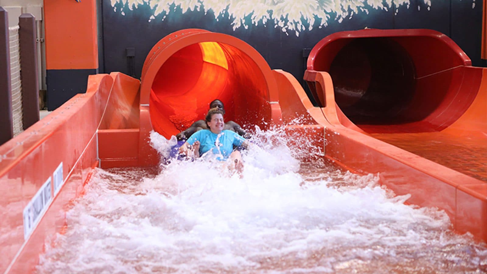 Riders coming out of a tube slide at the Kalahari indoor waterpark
