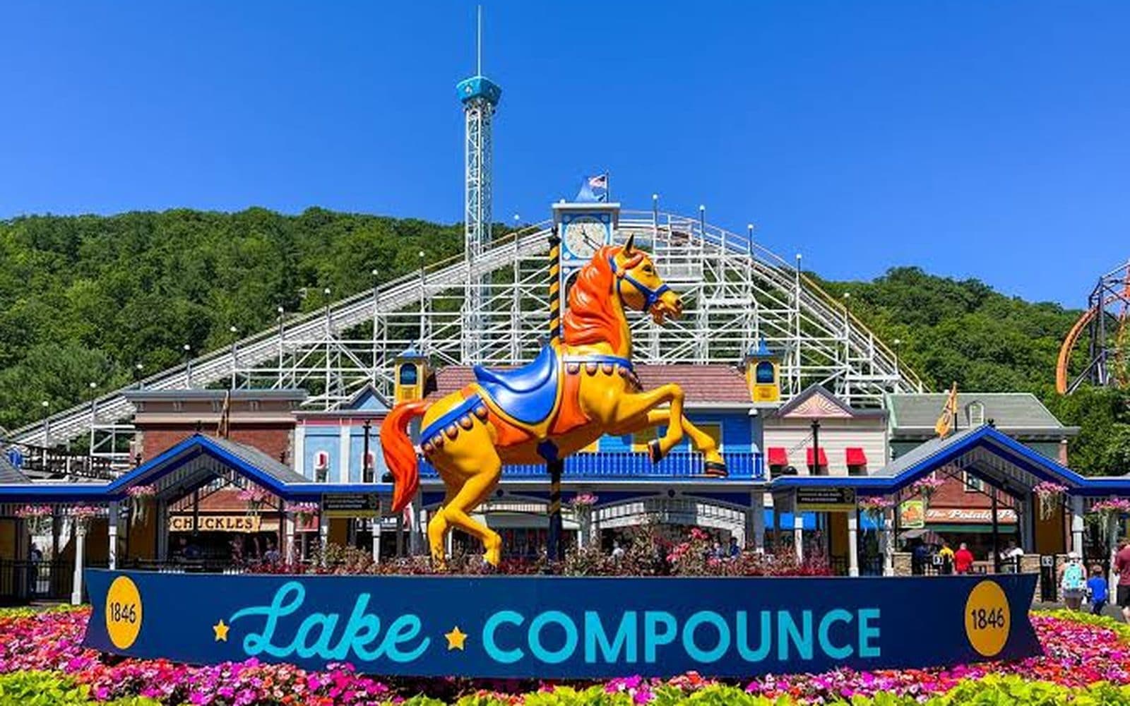 The Lake Compounce carousel horse in front of the roller coaster