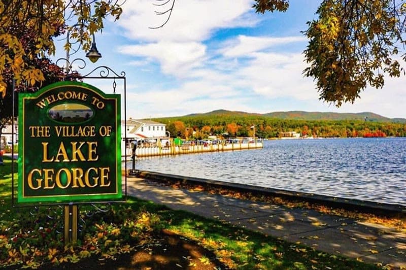The Village of Lake George welcome sign beside the lake
