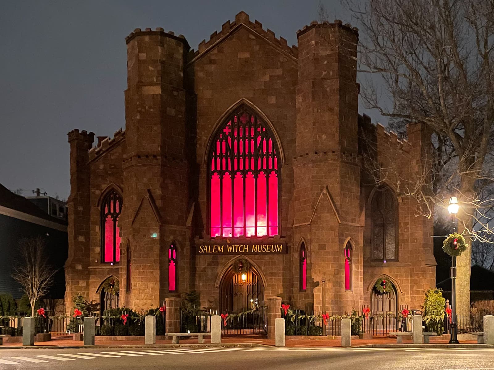 The Salem Witch Museum at night, with its windows glowing red